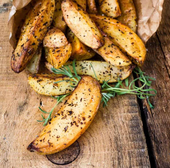 pile of French fries potato wedges with herbs