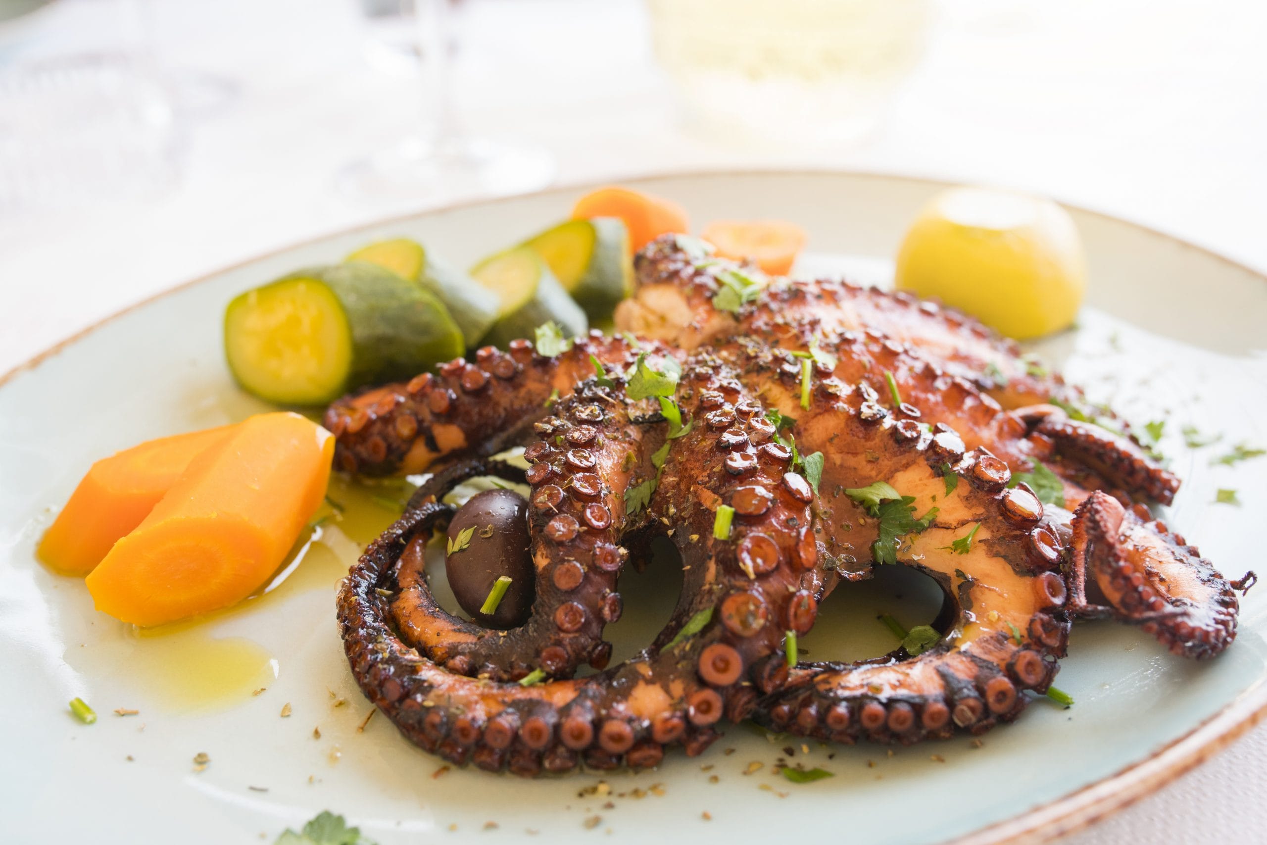 Greek seafood dishes on wooden tray